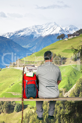 Man makes break from hiking and enjoying the view