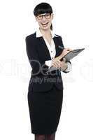 Charming businesswoman writing on notepad