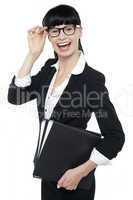 Cheerful female secretary carrying business files