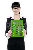 Pretty female executive showing calculator