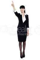 Business lady pointing her finger upwards
