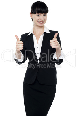 Successful businesswoman gesturing thumbs up