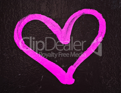 Pink love heart graffiti on painted wall