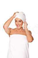 Beautiful woman tying a towel round her head