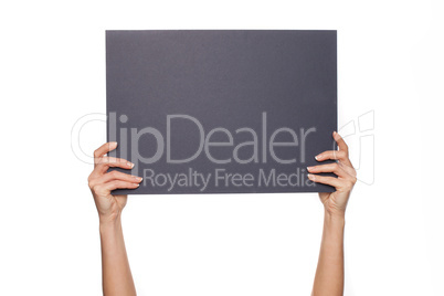 Woman's arms holding chalkboard