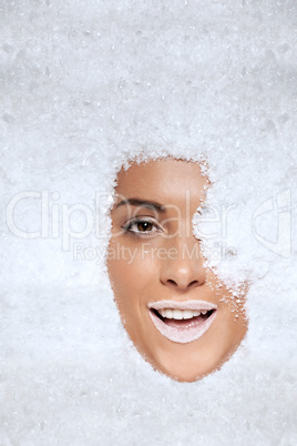 Laughing woman appearing through snow