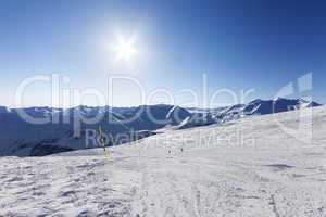 Ski slope and blue sky with sun