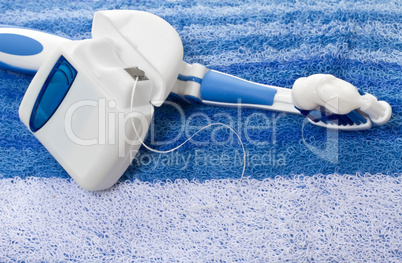 dental floss and toothbrush on a towel