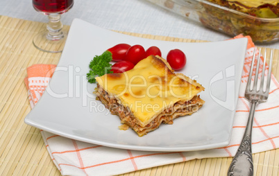 Lasagna with tomatoes, cheese and parsley