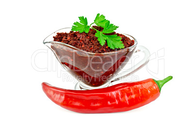 Ajika in a glass gravy boat with hot pepper