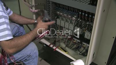 Electrician Works On Equipment