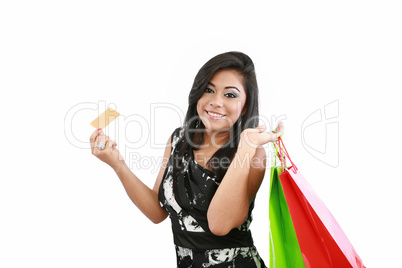 Young woman with shopping bags and credit card on a white backgr
