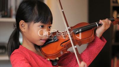 Asian Girl Practices Her Violin