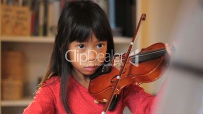 Six Year Old Asian Girl Practices Her Violin