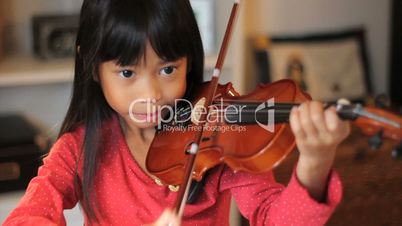 Asian Girl Practices Her Violin-High Angle