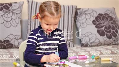 Little girl painting in concentration