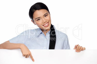 Asian businesswoman pointing to a signboard