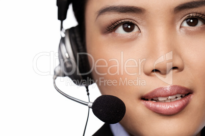 Closeup of an Asian lady wearing a headset