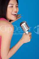 Laughing Asian woman with a microphone