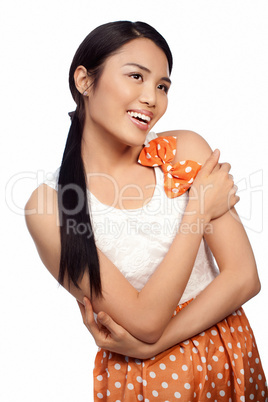 Smiling Asian girl in a polka dot dress