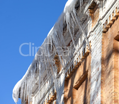 Snow-covered roof with icicles