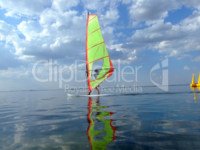 Windsurfer and its reflection in water of a gulf 2