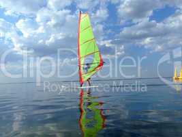Windsurfer and its reflection in water of a gulf 2