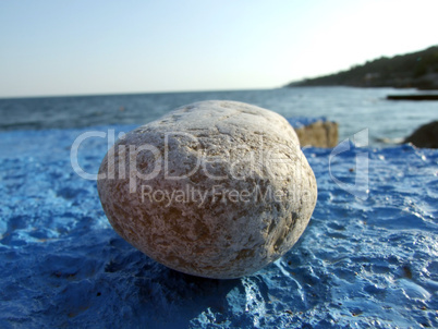 Greater pebble on a dark blue surface. Big picture