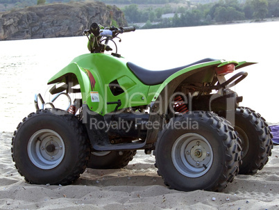 Small All Terrain Vehicle on coast of the river