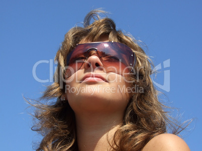 portrait of the girl in sunglasses on a background of the blue s portrait of the girl in sunglasses on a background of the blue s