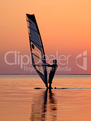 Silhouette of a wind-surfer on waves of a gulf on a sunset 3
