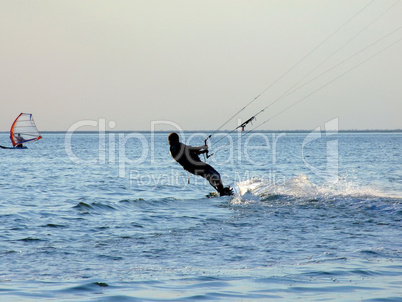 Silhouette of a kite-surf on waves of a gulf 1