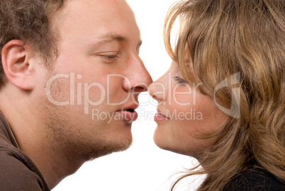 Portrait of young kissing couple. Isolated on white