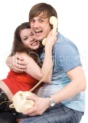 The young couple with old phone. Funny picture. Isolated