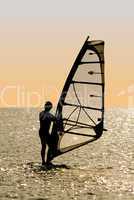 Silhouette of a windsurfer on waves of a gulf