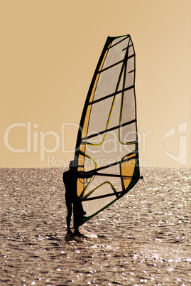 Silhouette of a windsurfer on waves