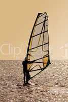 Silhouette of a windsurfer on waves