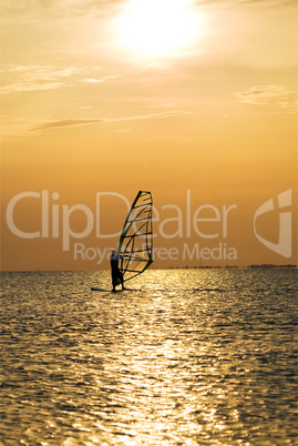 Silhouette of a windsurfer on a sunset