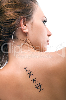 Tattoo on a back of the young woman. Isolated 3