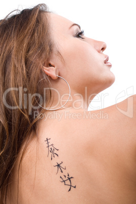 Tattoo on a back of the young woman. Isolated 4