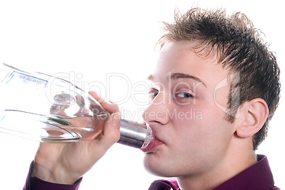 The young man drinks vodka from a bottle. Isolated