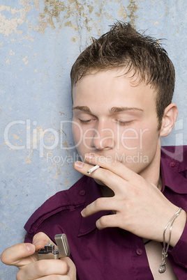 portrait of the young man with a cigarette and a lighter