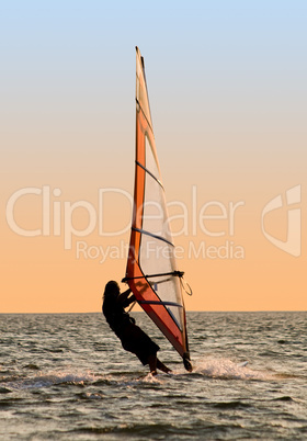 Silhouette of a windsurfer on a gulf