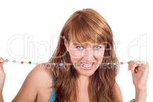 Portrait of the young beautiful woman with a beads in a teeth