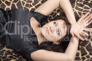 young beauty woman in black dress lies on a bed