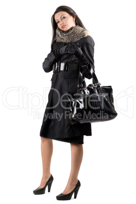 The young woman in a black coat. Isolated