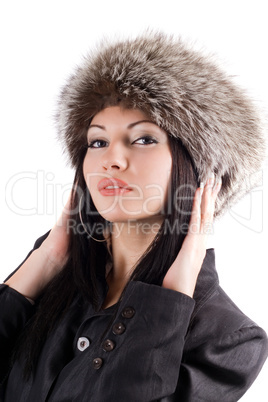 Portrait of the young woman in a fur cap. Isolated