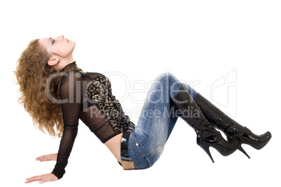 The young woman in blue jeans and black boots. Isolated