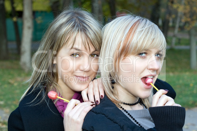 Portrait of the two young women with sugar candies