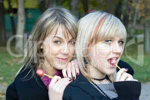 Portrait of the two young women with sugar candies